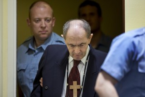 Tolimir is escorted by U.N. security guards as he arrives in the courtroom of the the Yugoslav war crimes tribunal who delivered its judgment in his appeal case in The Hague